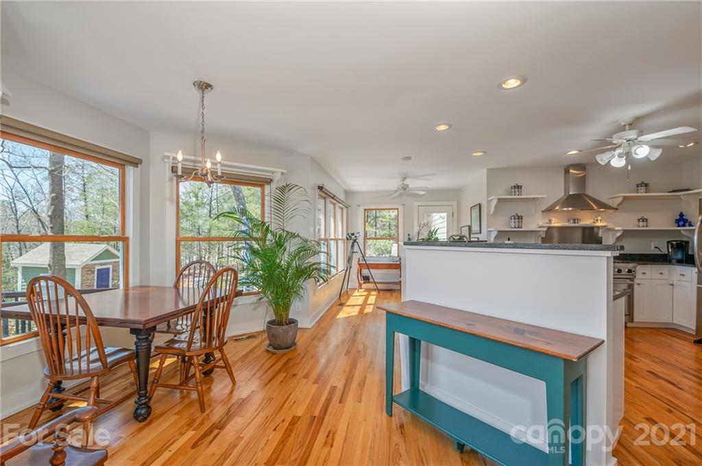 658 South Cove Road Mill Spring, NC 28756 - Photo 13 of 46 a kitchen with stainless steel appliances granite countertop wooden floor window and cabinets