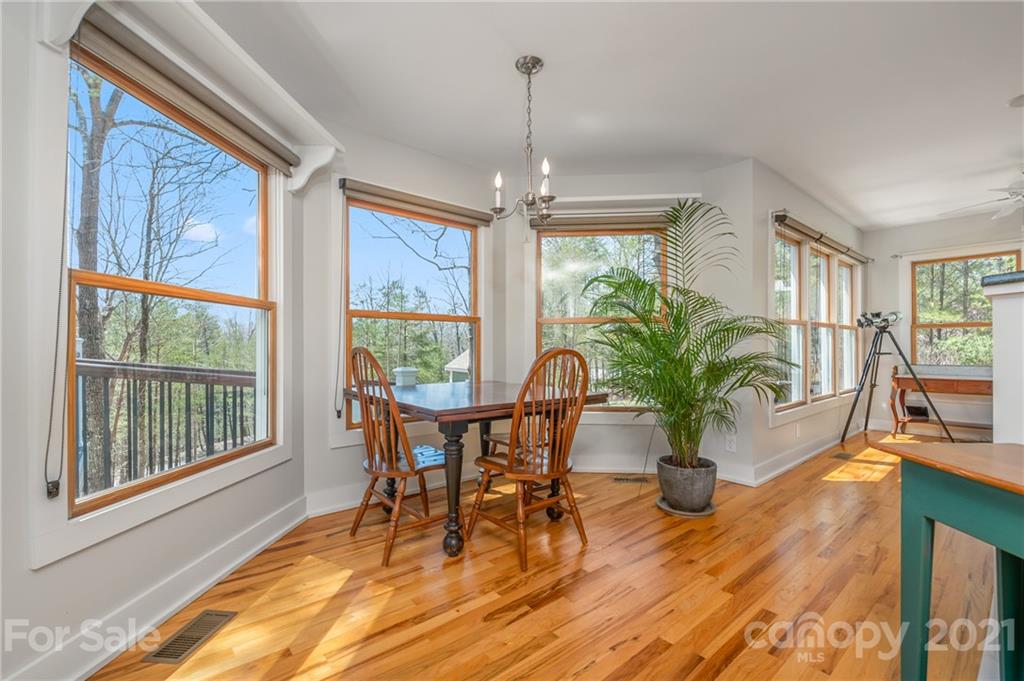 658 South Cove Road Mill Spring, NC 28756 - Photo 14 of 46 a view of a dining room with furniture window and wooden floor