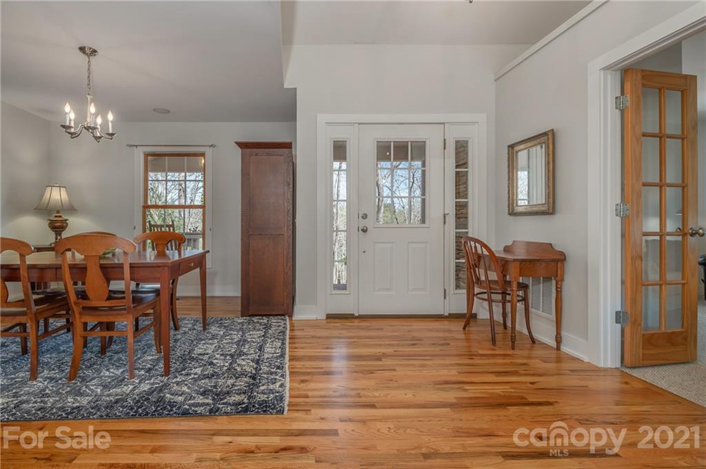 658 South Cove Road Mill Spring, NC 28756 - Photo 20 of 46 a view of a dining room with furniture and wooden floor