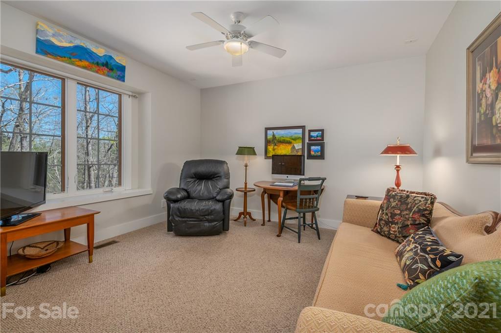 658 South Cove Road Mill Spring, NC 28756 - Photo 23 of 46 a living room with furniture and a flat screen tv