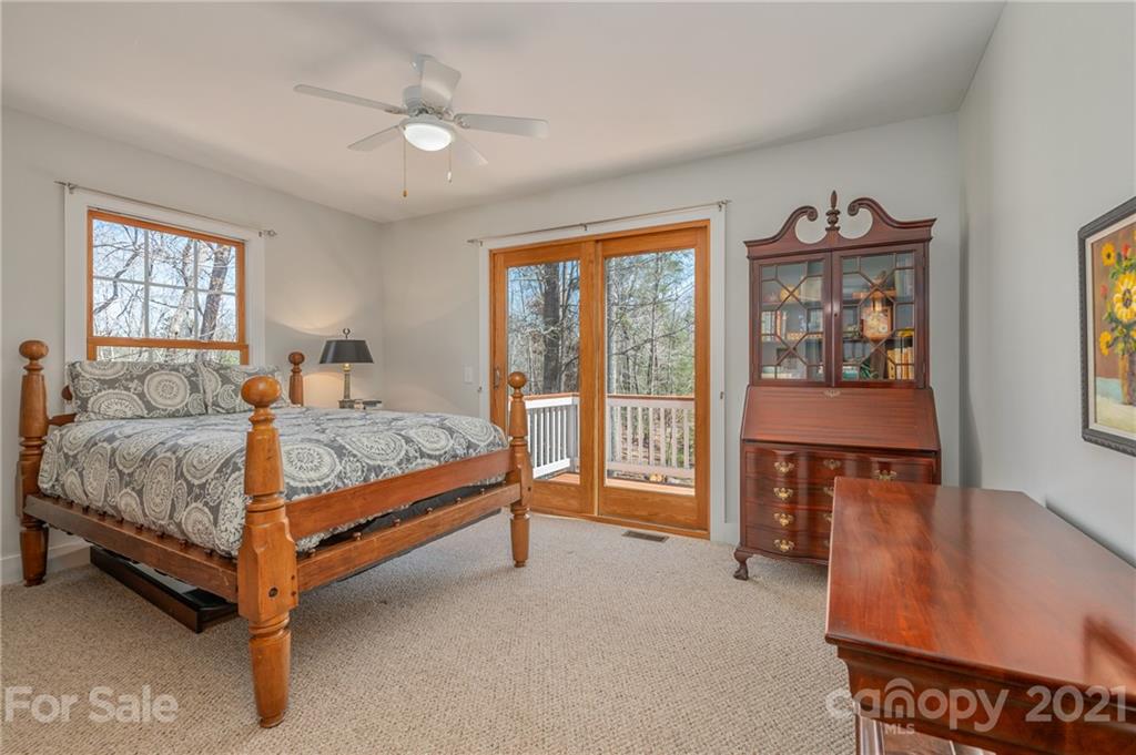 658 South Cove Road Mill Spring, NC 28756 - Photo 24 of 46 a bed sitting in a bedroom next to a window