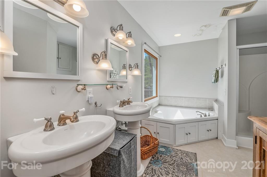 658 South Cove Road Mill Spring, NC 28756 - Photo 26 of 46 a bathroom with a sink and a mirror