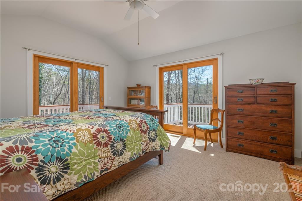 658 South Cove Road Mill Spring, NC 28756 - Photo 27 of 46 a bedroom with a bed and a tv