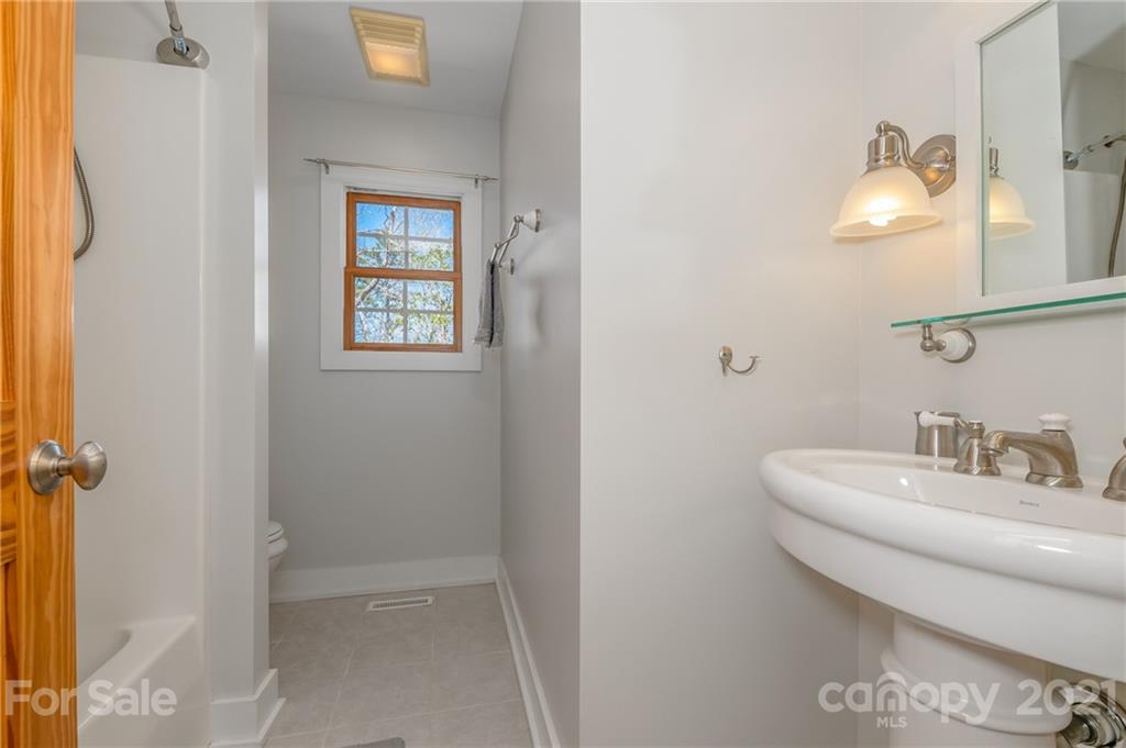 658 South Cove Road Mill Spring, NC 28756 - Photo 29 of 46 a bathroom with a sink and a mirror