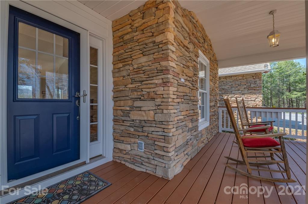 658 South Cove Road Mill Spring, NC 28756 - Photo 31 of 46 a balcony with wooden floor and furniture