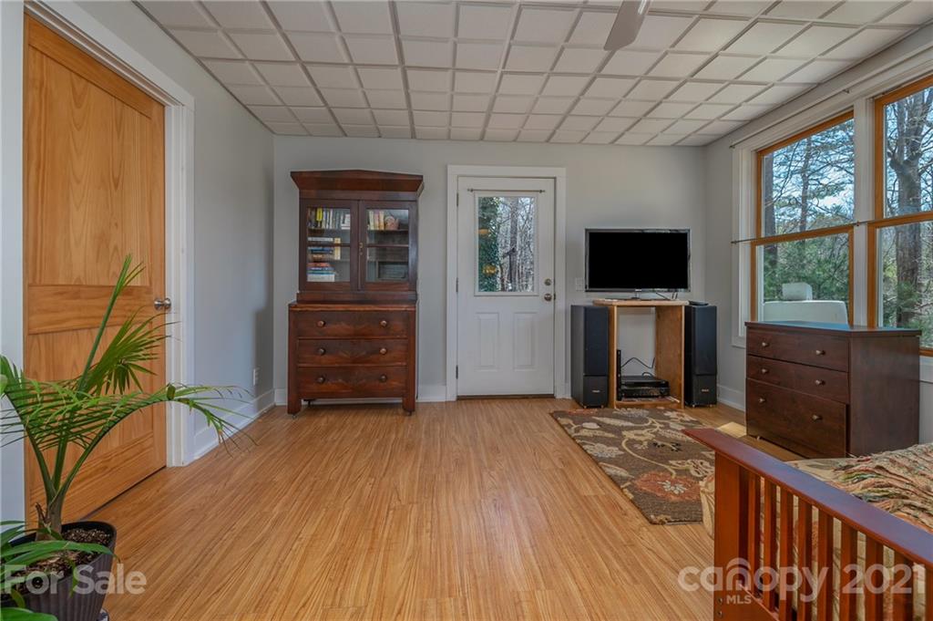 658 South Cove Road Mill Spring, NC 28756 - Photo 33 of 46 a view of a livingroom with a flat screen tv wooden floor and a window