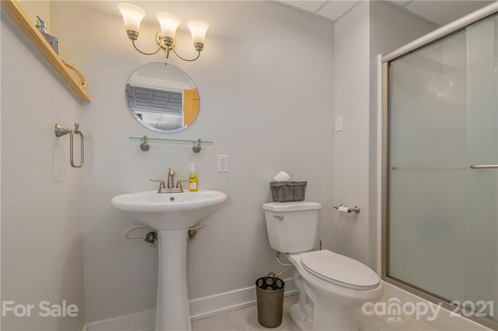 658 South Cove Road Mill Spring, NC 28756 - Photo 36 of 46 a bathroom with a sink a toilet and mirror