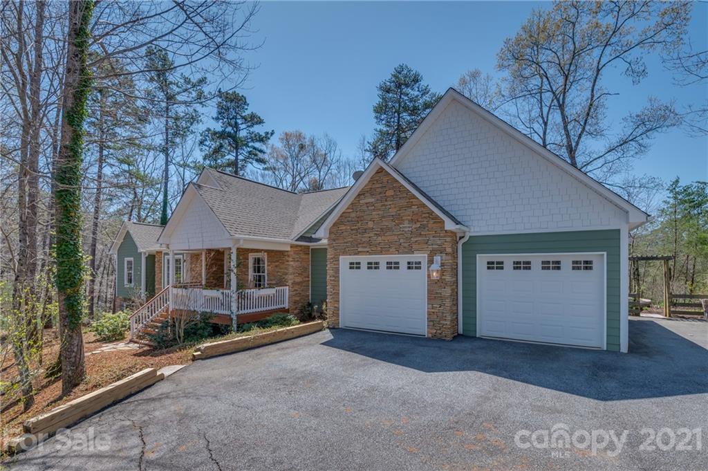 658 South Cove Road Mill Spring, NC 28756 - Photo 5 of 46 a view of a house with a yard and garage