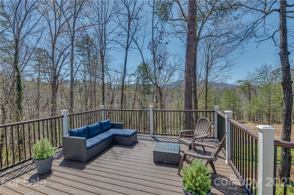 658 South Cove Road Mill Spring, NC 28756 - Photo 9 of 46 a view of a roof deck with couches and wooden floor