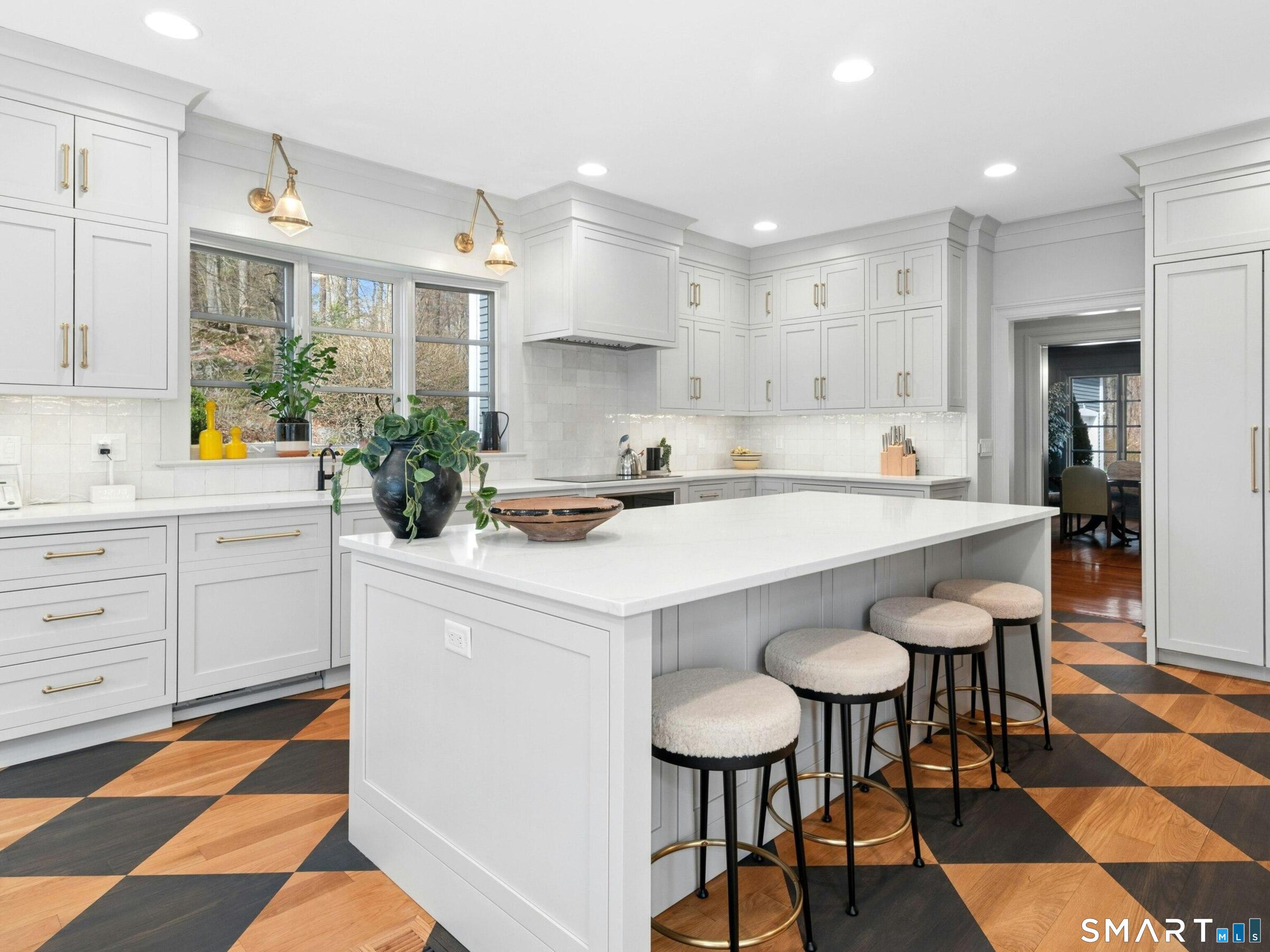 760 Smith Ridge Road New Canaan, CT 06840 - Photo 12 of 38 a kitchen with a sink a stove a dining table and chairs
