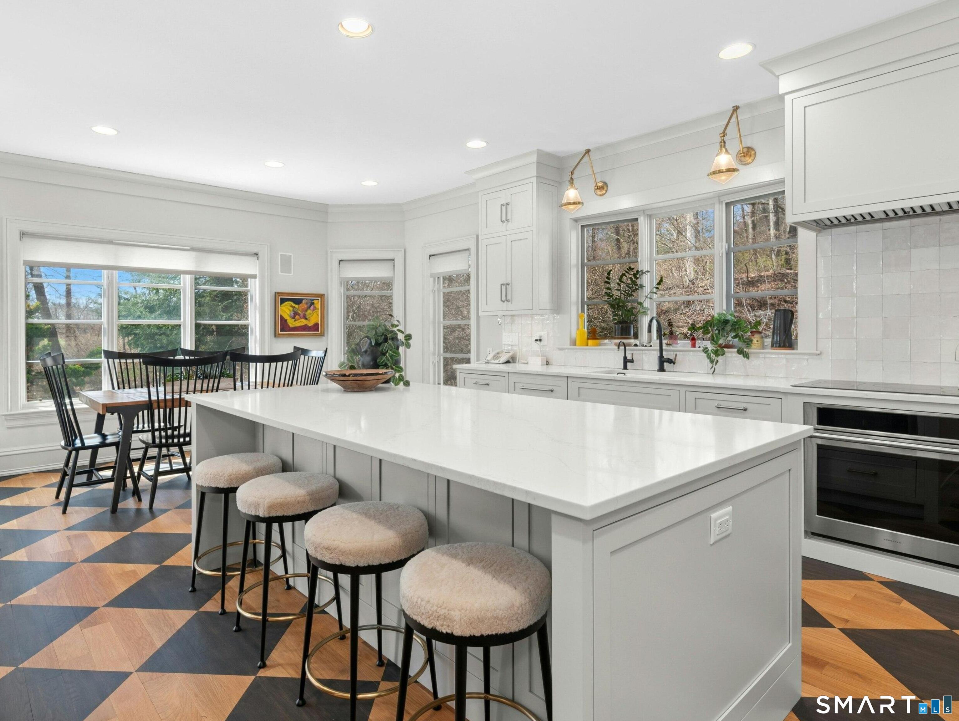 760 Smith Ridge Road New Canaan, CT 06840 - Photo 13 of 38 a kitchen with center island table and chairs in it