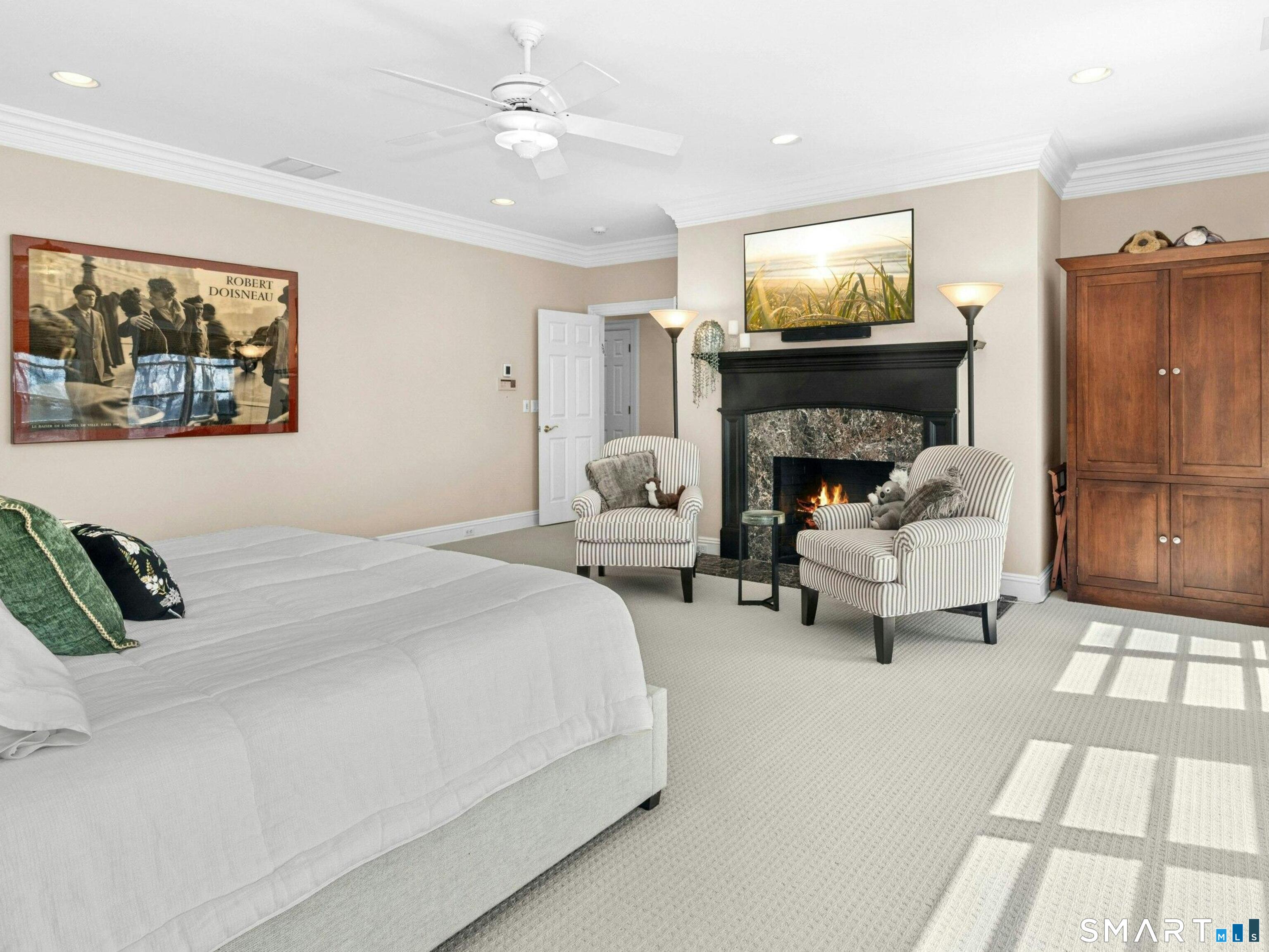 760 Smith Ridge Road New Canaan, CT 06840 - Photo 23 of 38 a bedroom with a bed and a fireplace