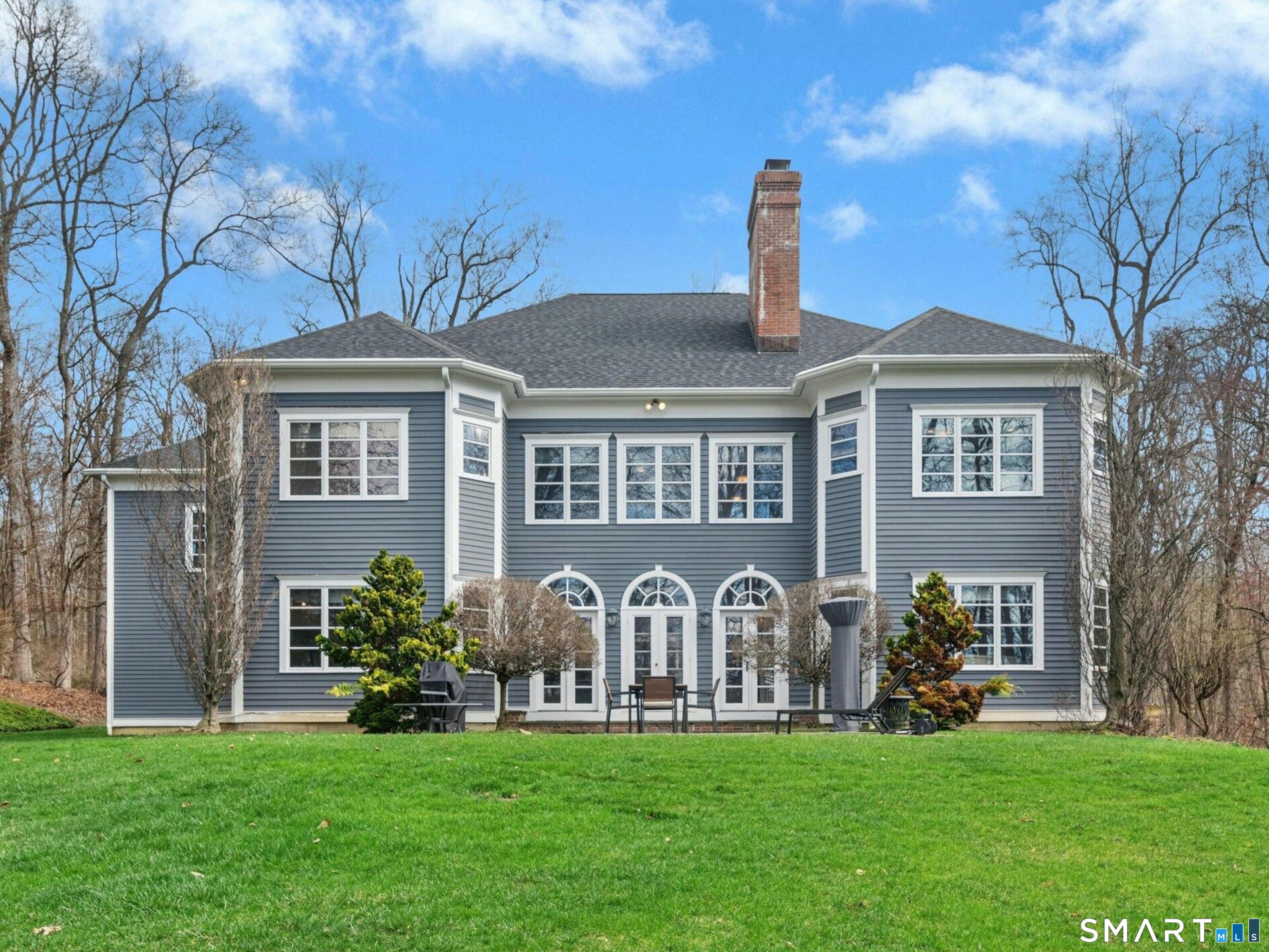 760 Smith Ridge Road New Canaan, CT 06840 - Photo 30 of 38 a front view of a house with a garden
