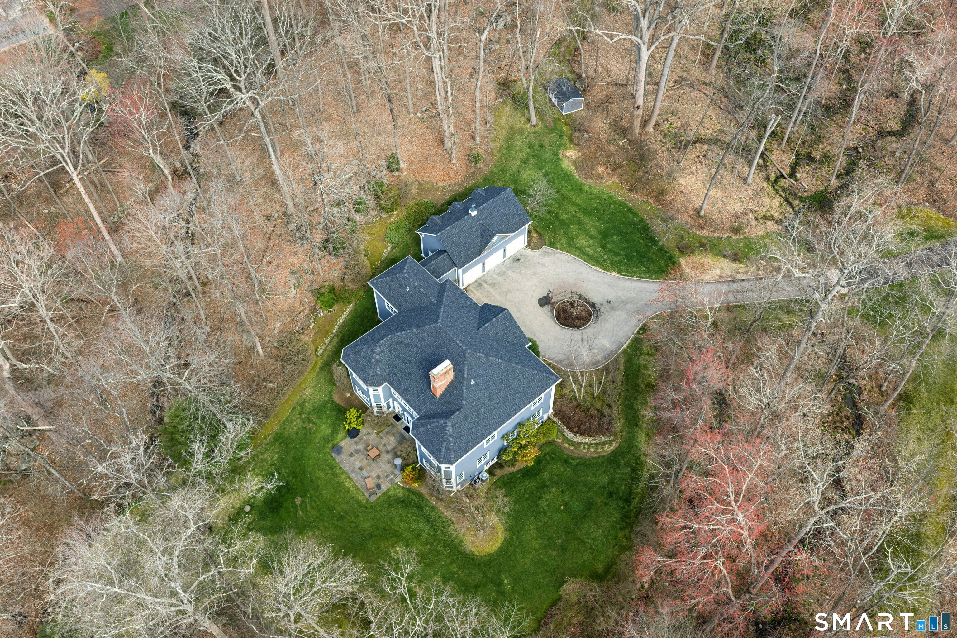 760 Smith Ridge Road New Canaan, CT 06840 - Photo 34 of 38 an aerial view of a house with a yard and trees