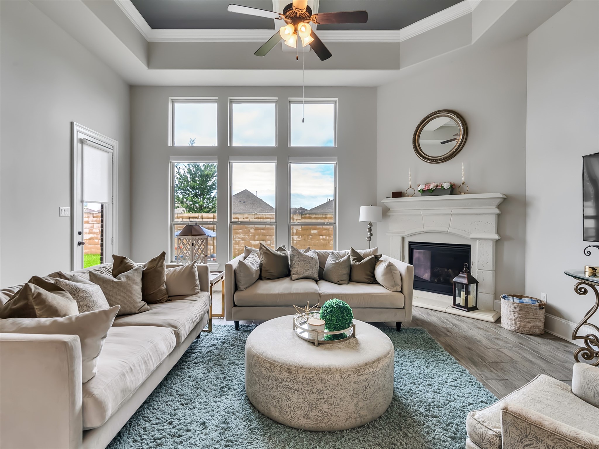 10302 Muir Peak Drive Rosharon, TX 77583 - Photo 13 of 40 This spacious family room features coffered ceilings, crown molding, and large windows.