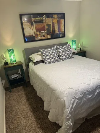 a bed sitting in a bedroom next to a window