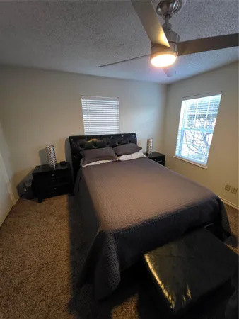 a bed sitting in a bedroom next to a window