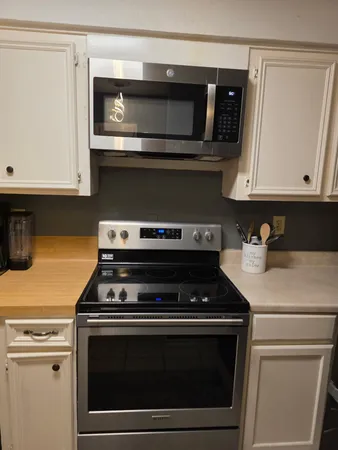a stove top oven sitting inside of a kitchen