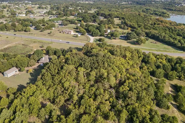 a view of a yard with wooden fence