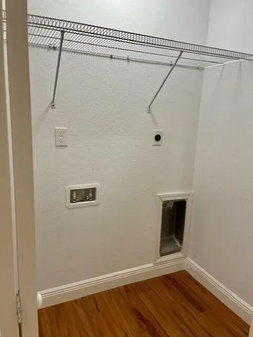 a view of a room with wooden floor and fan