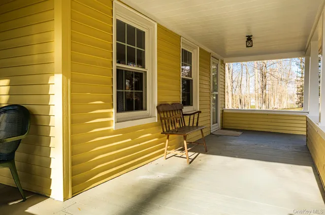 a house view with a bench and wooden floor