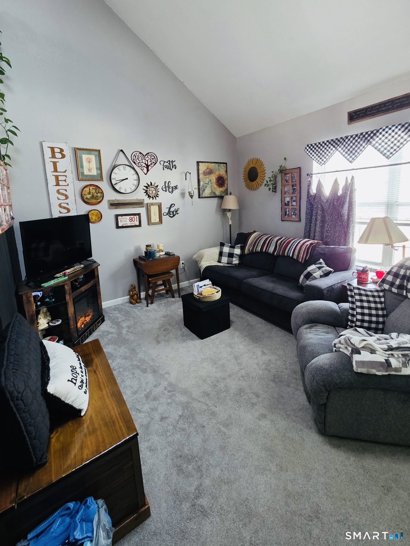 a living room with furniture and a flat screen tv