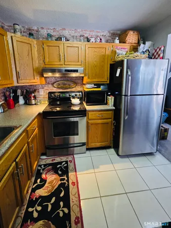 a kitchen with stainless steel appliances a stove a sink and a refrigerator
