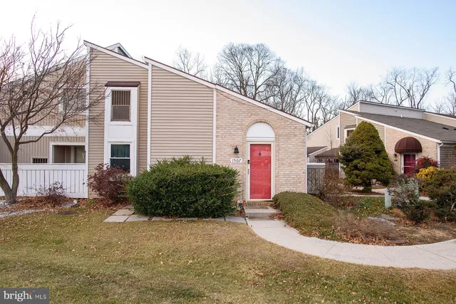 a front view of house with yard and trees around