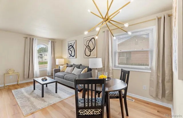 a kitchen with stainless steel appliances a refrigerator stove and white cabinets