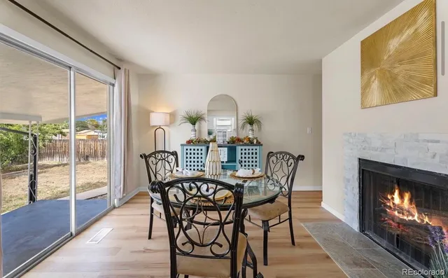 a kitchen with a table chairs refrigerator and cabinets