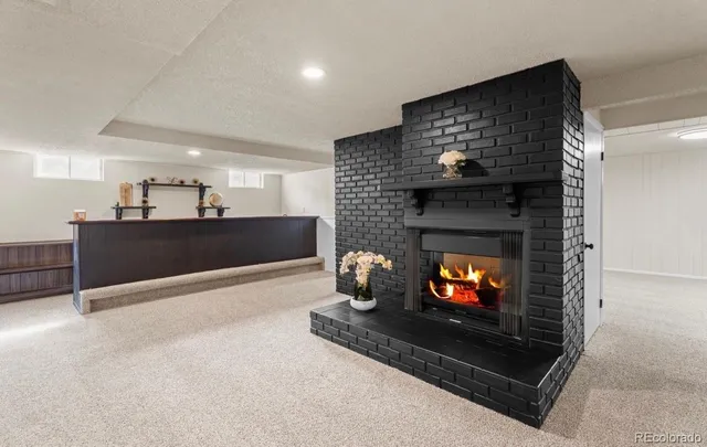 a view of an empty room and fire place