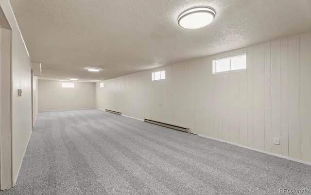 an empty room with a empty space and windows