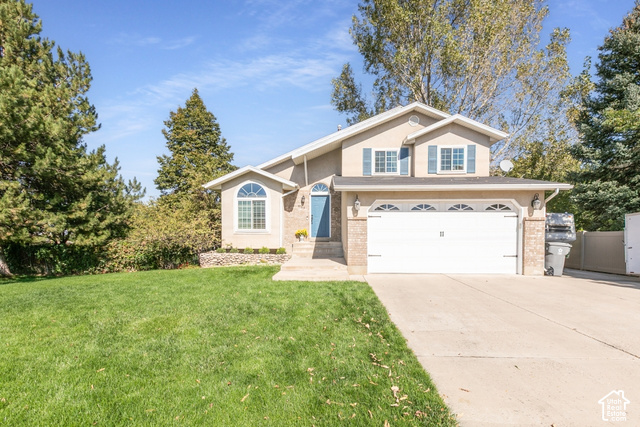 1764 West 1200th Street North Mapleton, UT 84664 - Photo 2 of 35 Two-story stucco exterior with a two-car garage, concrete driveway, and front lawn