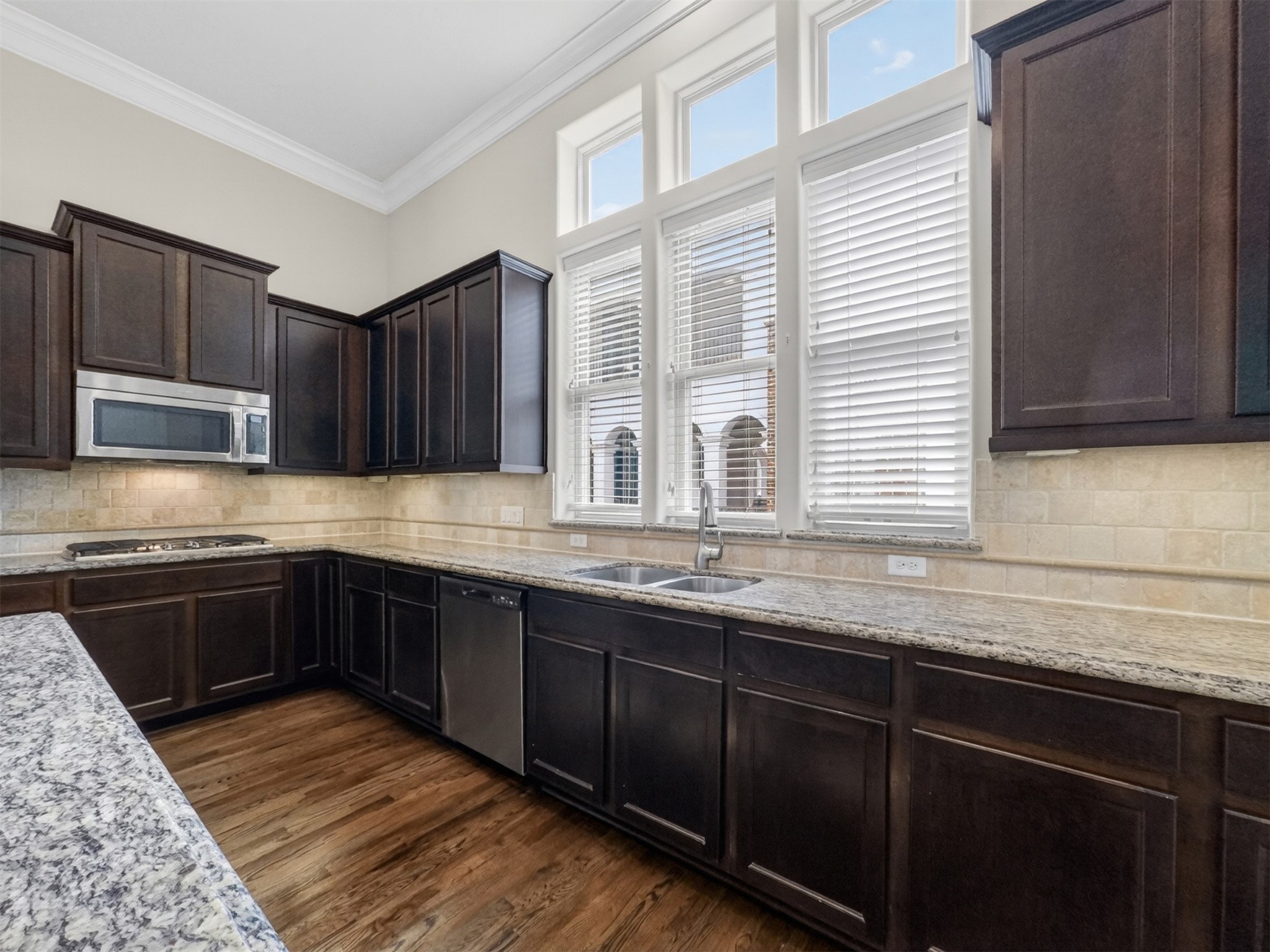 2810 Capitol Street Houston, TX 77003 - Photo 14 of 33 a kitchen with granite countertop wooden cabinets a stove top oven and granite counter tops