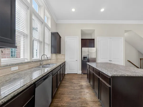 a kitchen with granite countertop kitchen island a sink stove and granite counter top
