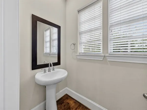 a bathroom with a sink a mirror and a window