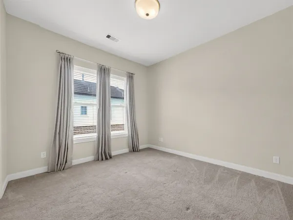 an empty room with closet and window