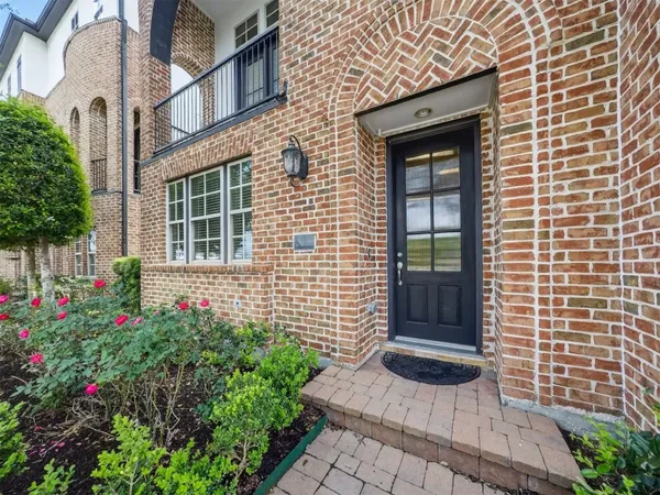 a view of a house with potted plants