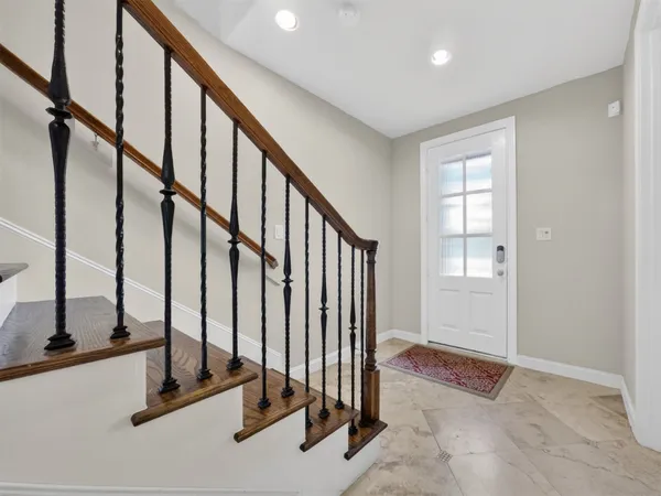 a view of an entryway with wooden floor