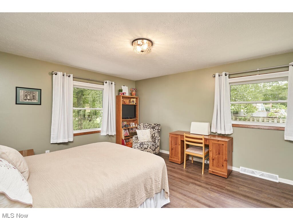 5535 River Styx Road Medina, OH 44256 - Photo 19 of 27 Luxury vinyl floored bedroom with multiple windows and a textured ceiling