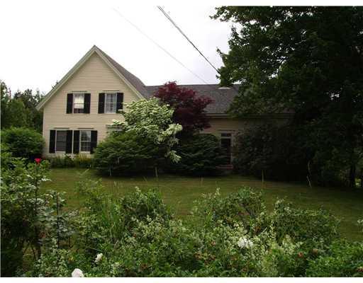 Exterior Front. Roses border lawn at...