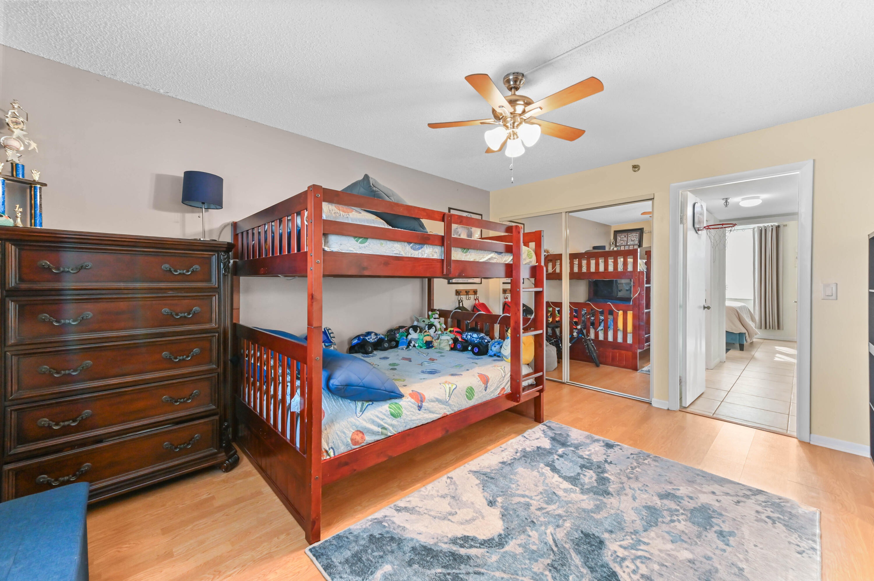 198 Northwest 67th Street, Unit 207 Boca Raton, FL 33487 - Photo 29 of 42 a bedroom with a bed and a chandelier