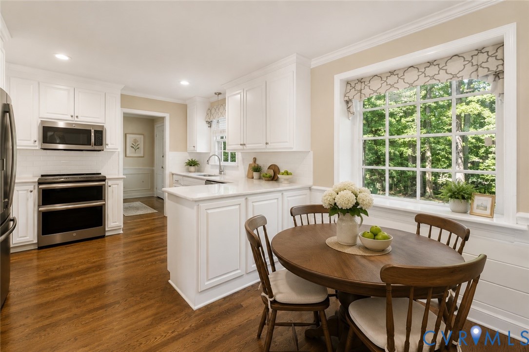 11520 Ivywood Road Chester, VA 23831 - Photo 7 of 35 White kitchen with stainless appliances and eat in