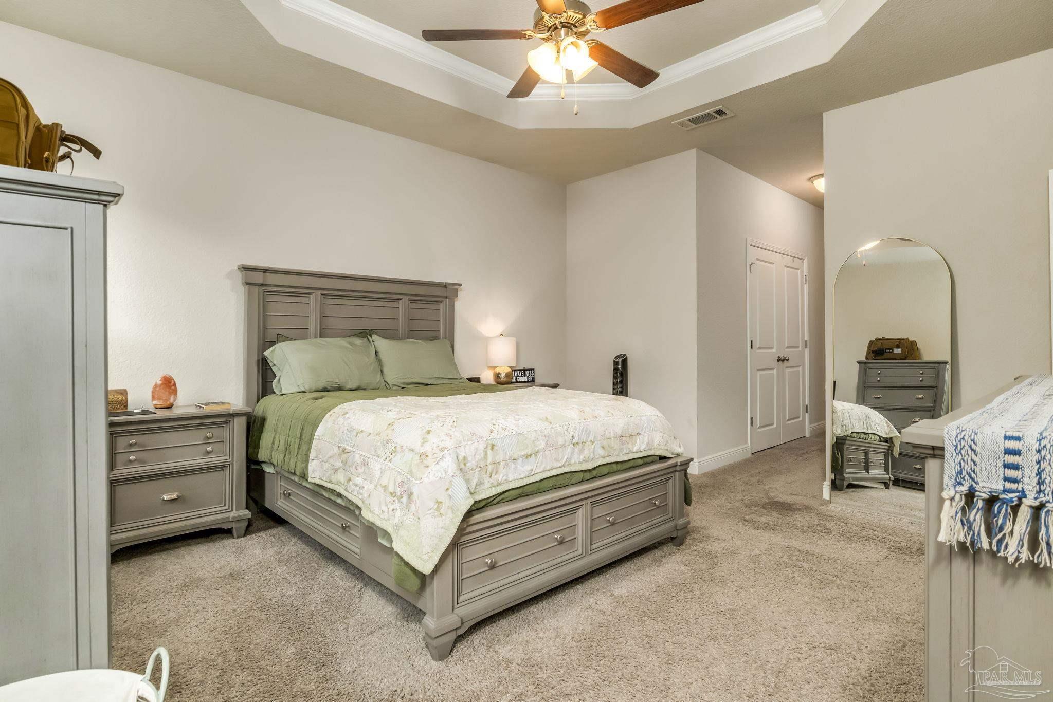 5185 Parkside Drive Pace, FL 32571 - Photo 19 of 43 a bedroom with a bed and a chandelier