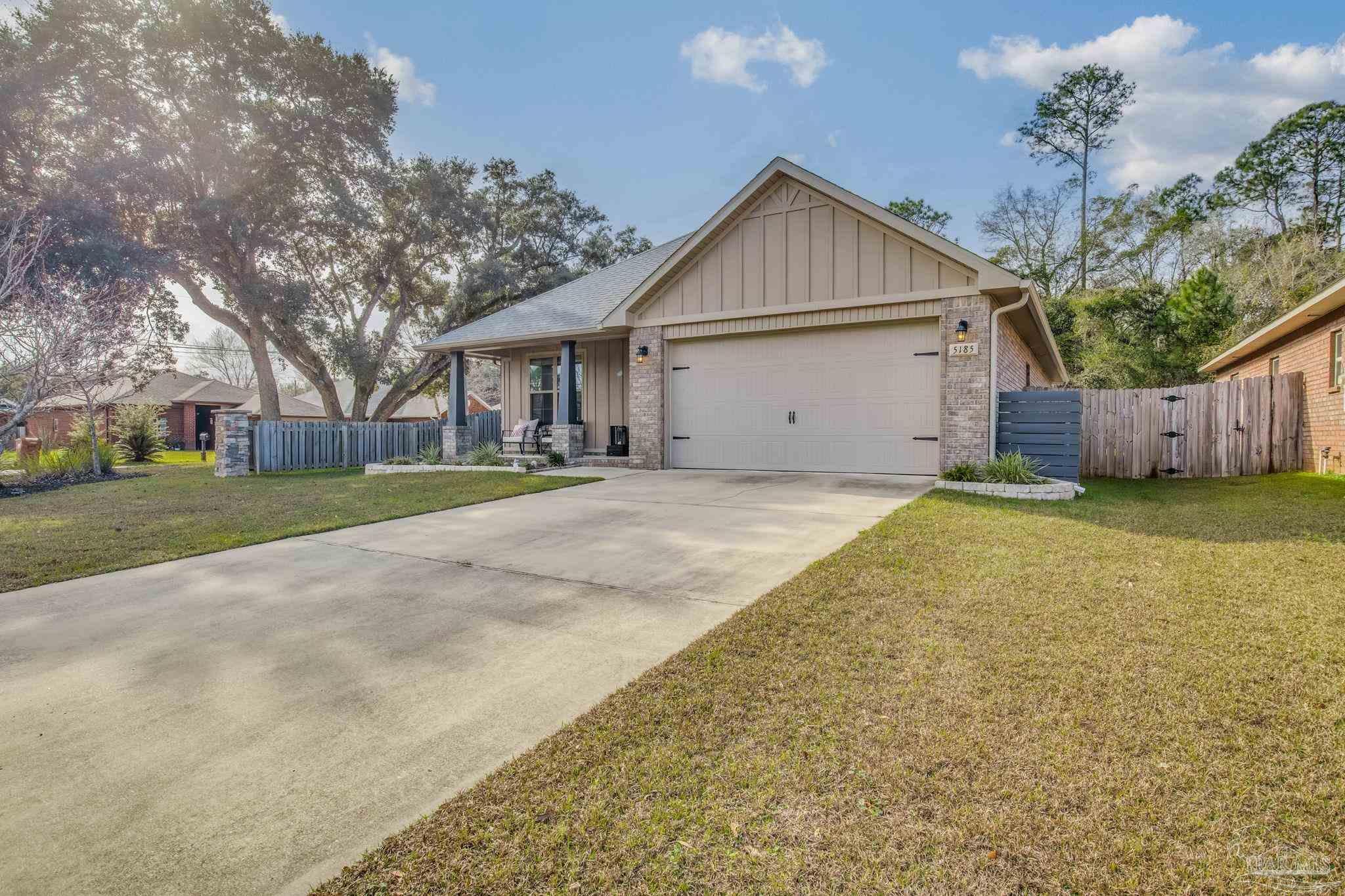 5185 Parkside Drive Pace, FL 32571 - Photo 2 of 43 a view of a house with a yard