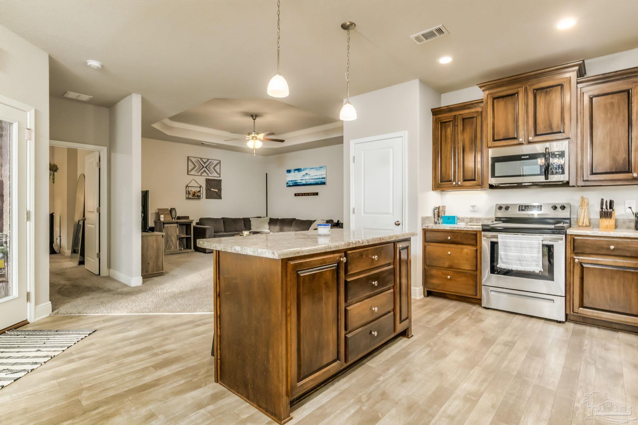 5185 Parkside Drive Pace, FL 32571 - Photo 24 of 43 a kitchen with white cabinets and stainless steel appliances