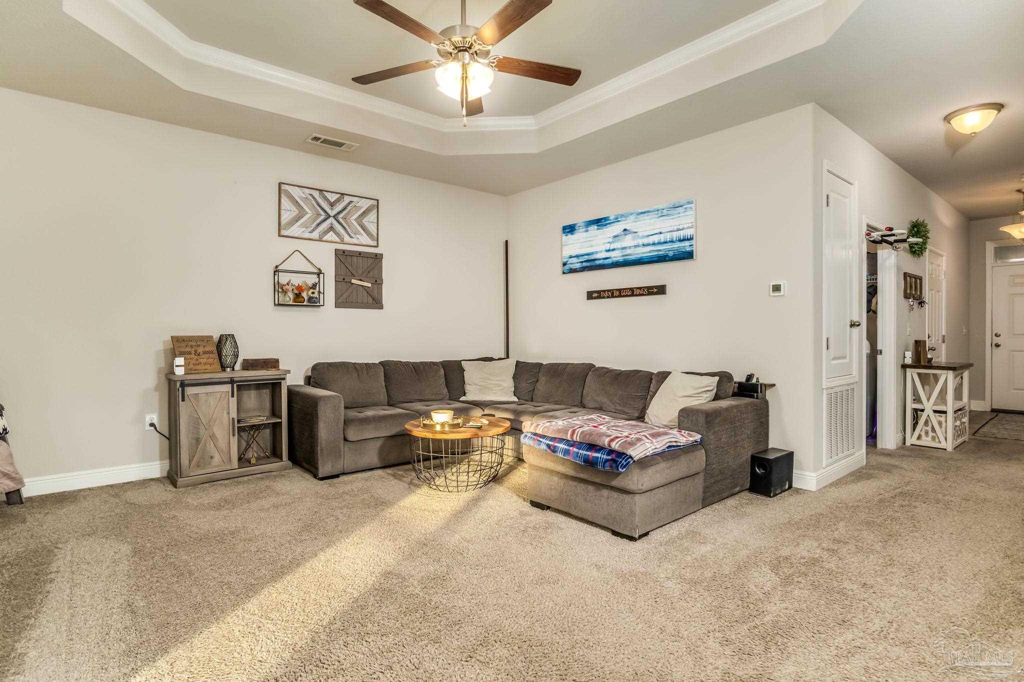 5185 Parkside Drive Pace, FL 32571 - Photo 31 of 43 a living room with furniture and a chandelier