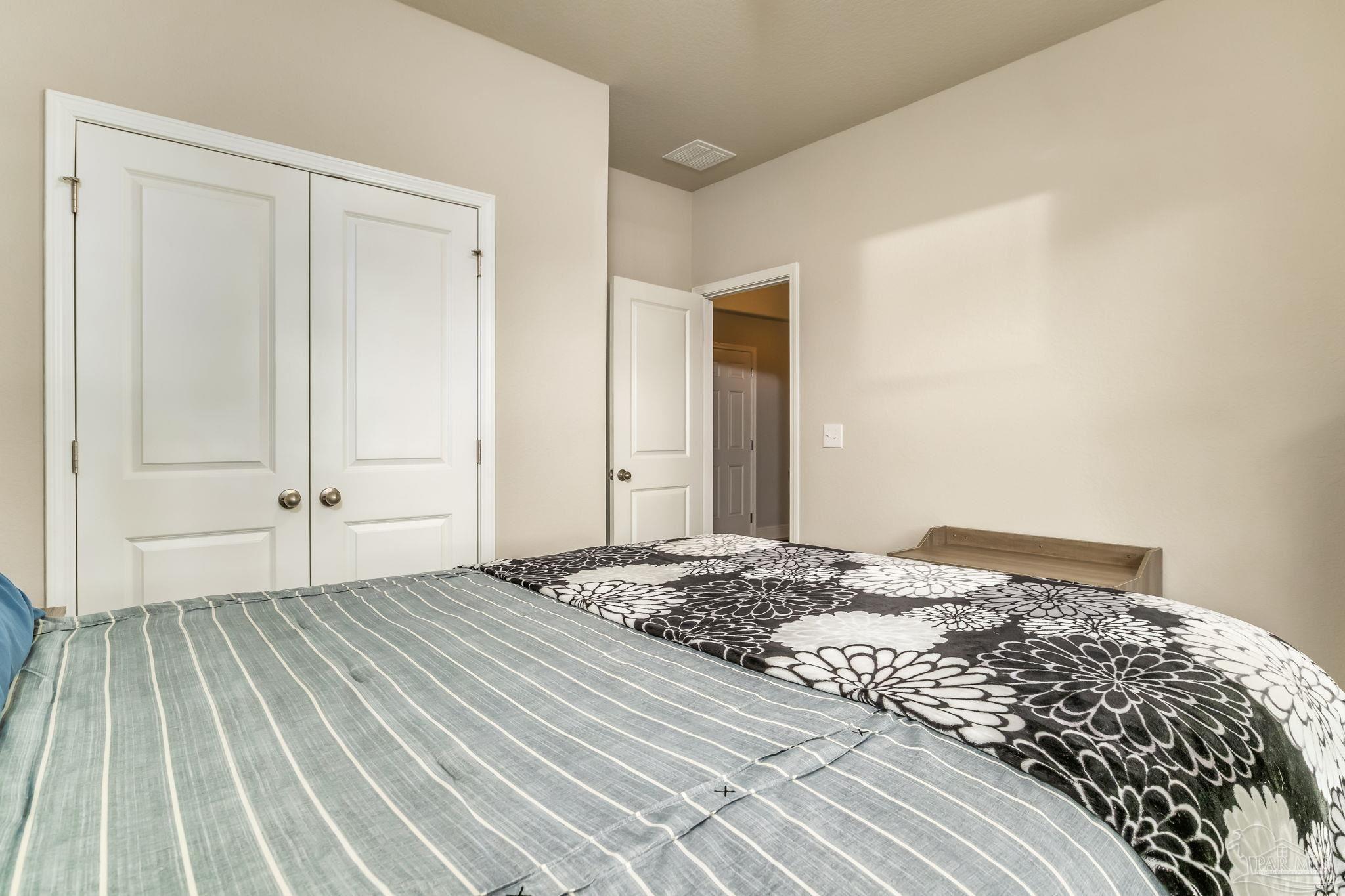 5185 Parkside Drive Pace, FL 32571 - Photo 36 of 43 a bedroom with a bed and a rug