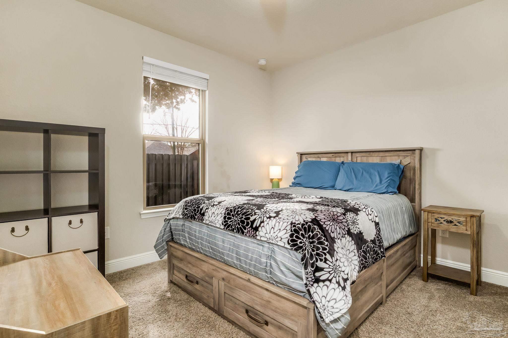 5185 Parkside Drive Pace, FL 32571 - Photo 37 of 43 a bedroom with a bed and a cabinets