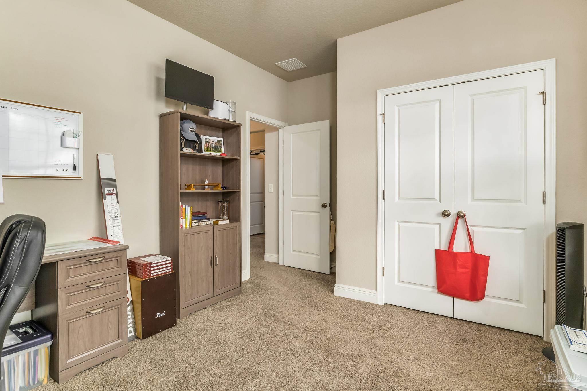 5185 Parkside Drive Pace, FL 32571 - Photo 38 of 43 a view of room with cabinet and flat screen tv